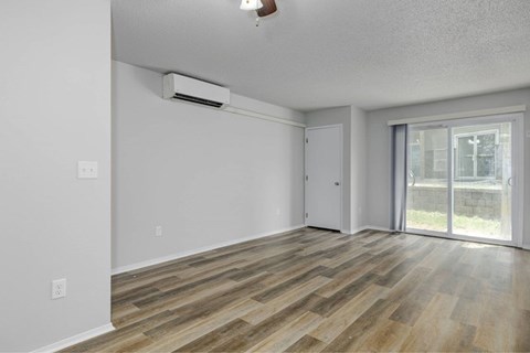 A room with wooden flooring and a sliding glass door.at Fish Creek, Norwalk